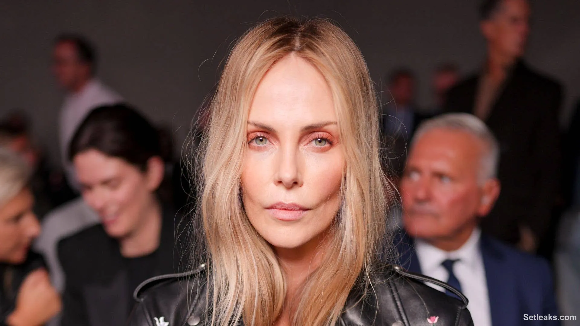 Charlize Theron opts for nothing under her leather biker jacket for ...