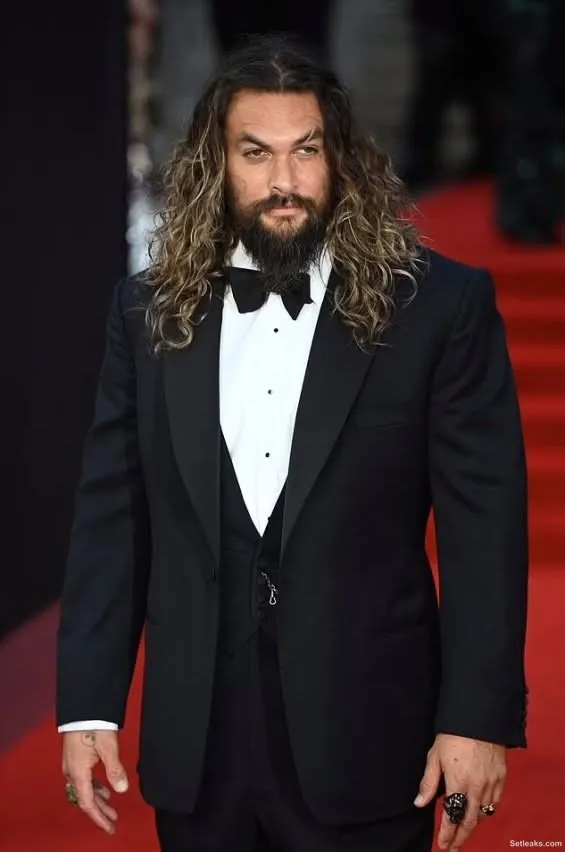 Jason Momoa with two children on the red carpet at the...